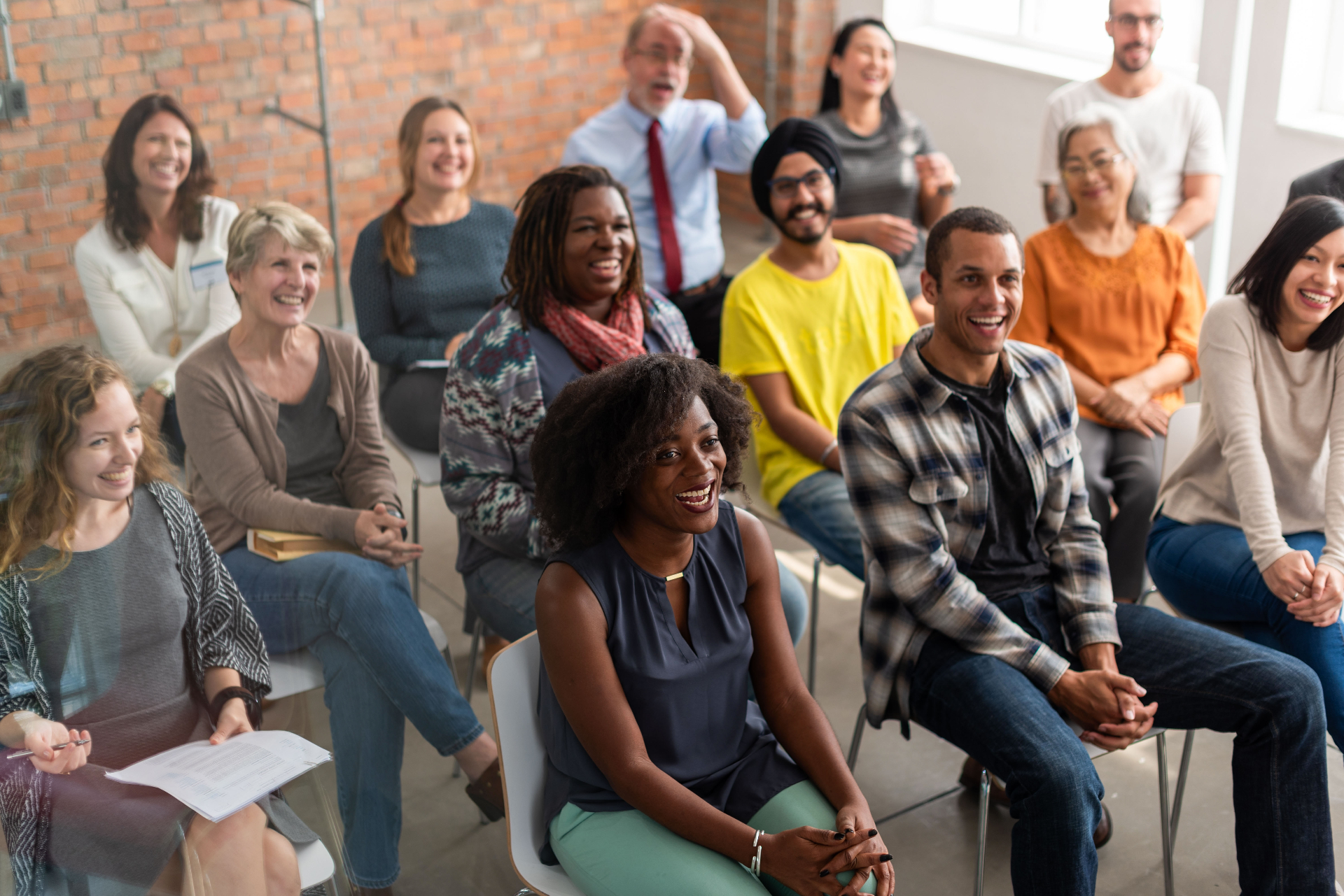 Diverse group of bariatric support group attendees seated together in a welcoming meeting space